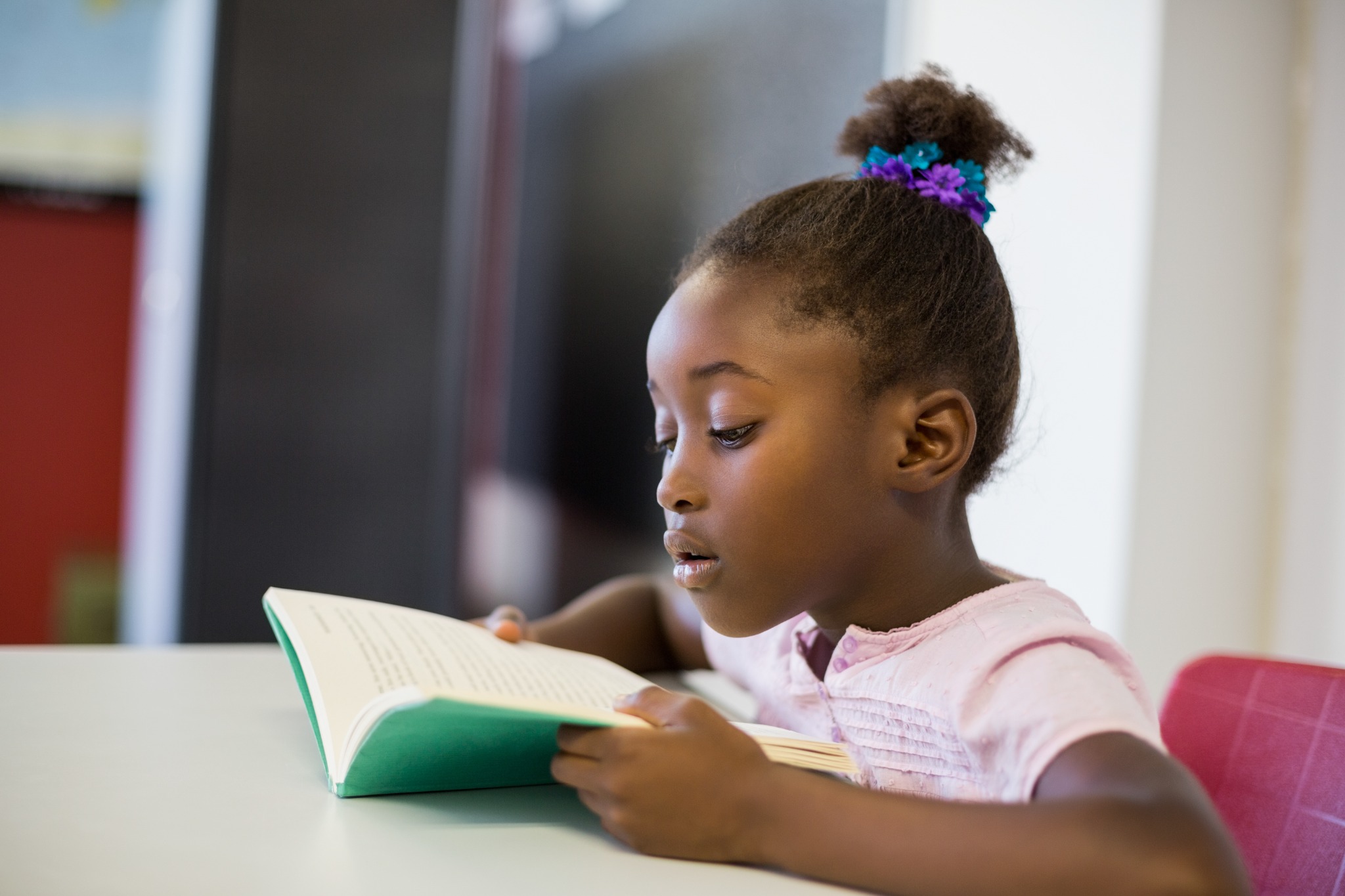 A student reads a book at school.